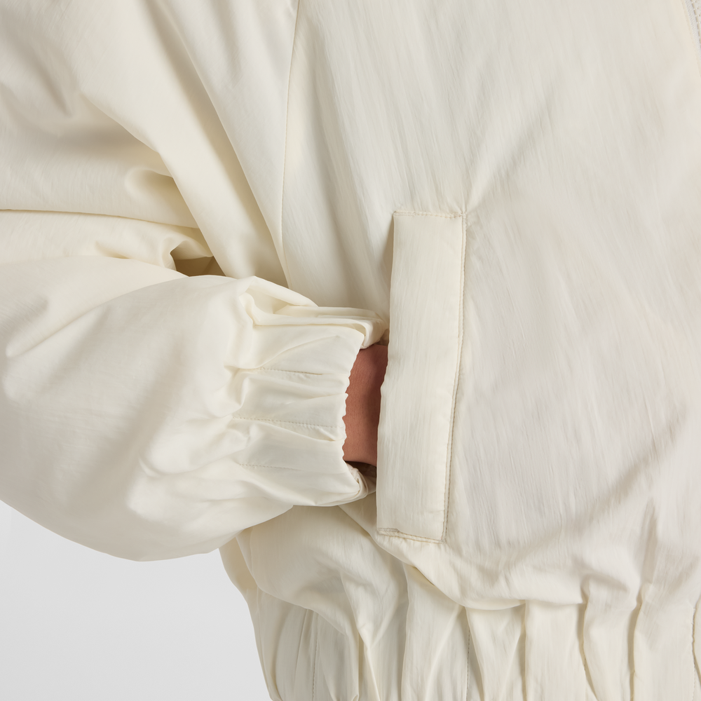 Kurtka damska New Balance WJ61D8YXSST​ – beżowa