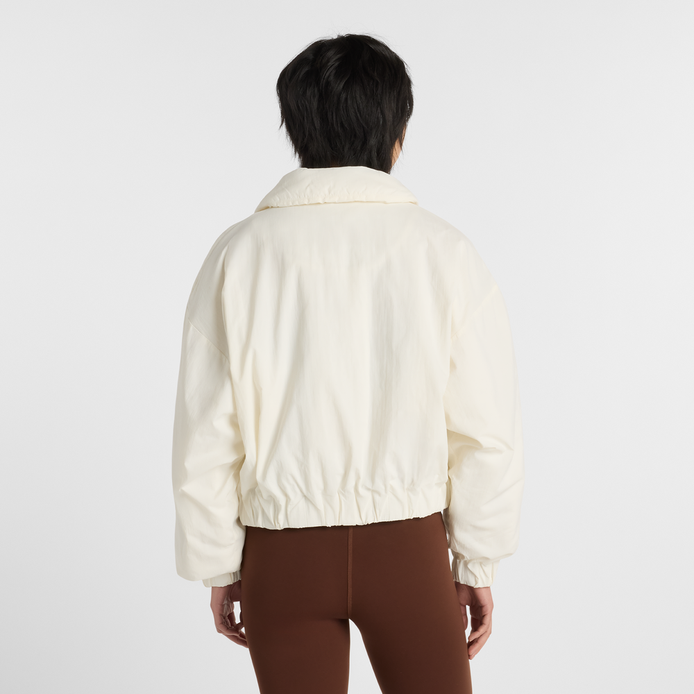 Kurtka damska New Balance WJ61D8YXSST​ – beżowa