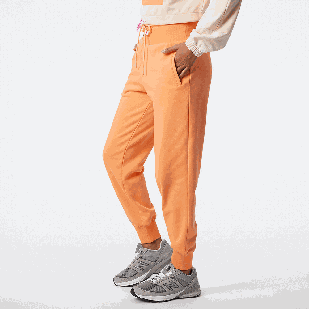 Spodnie New Balance WP21503PGZ – pomarańczowe