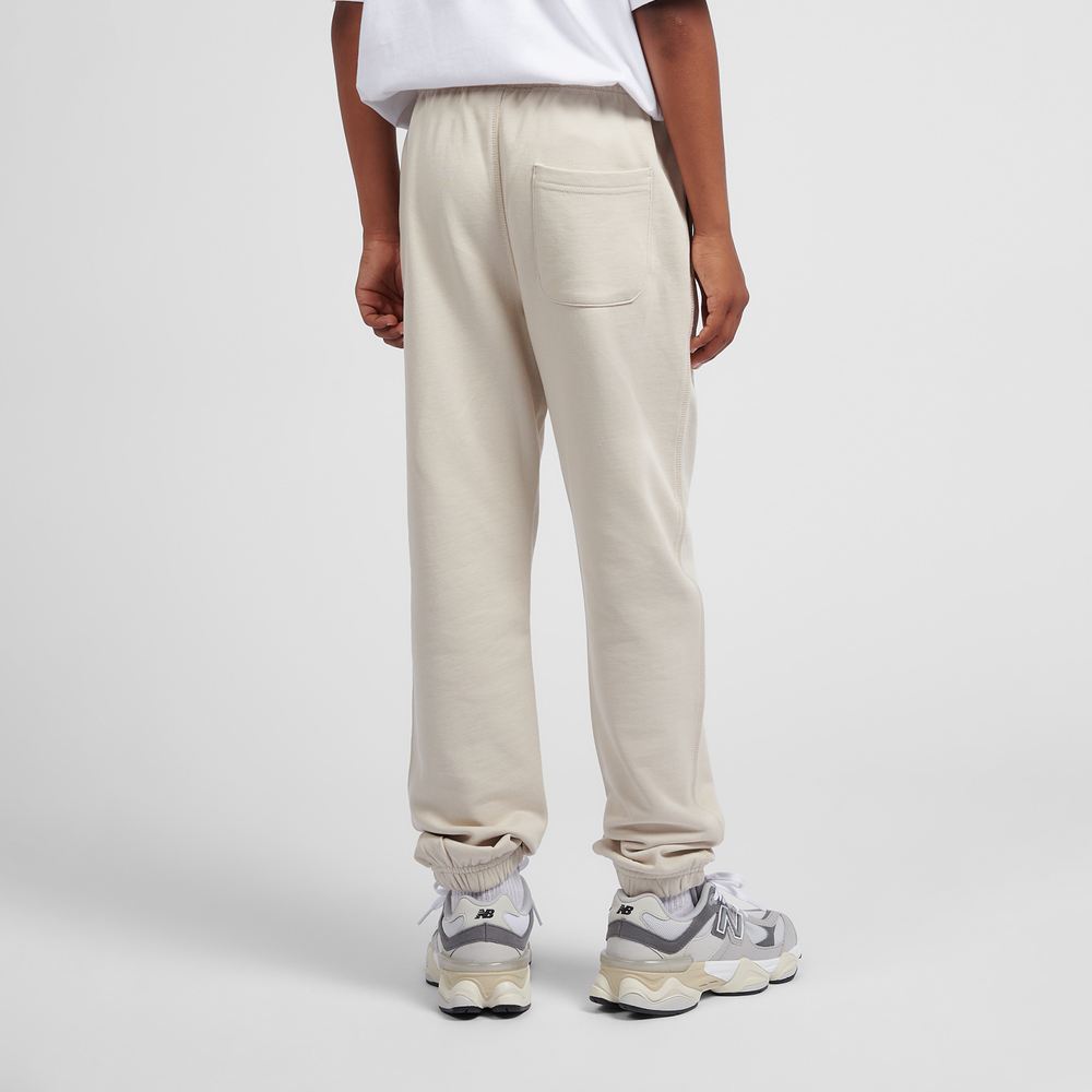 Spodnie dziecięce New Balance LAKB0060TWF – beżowe