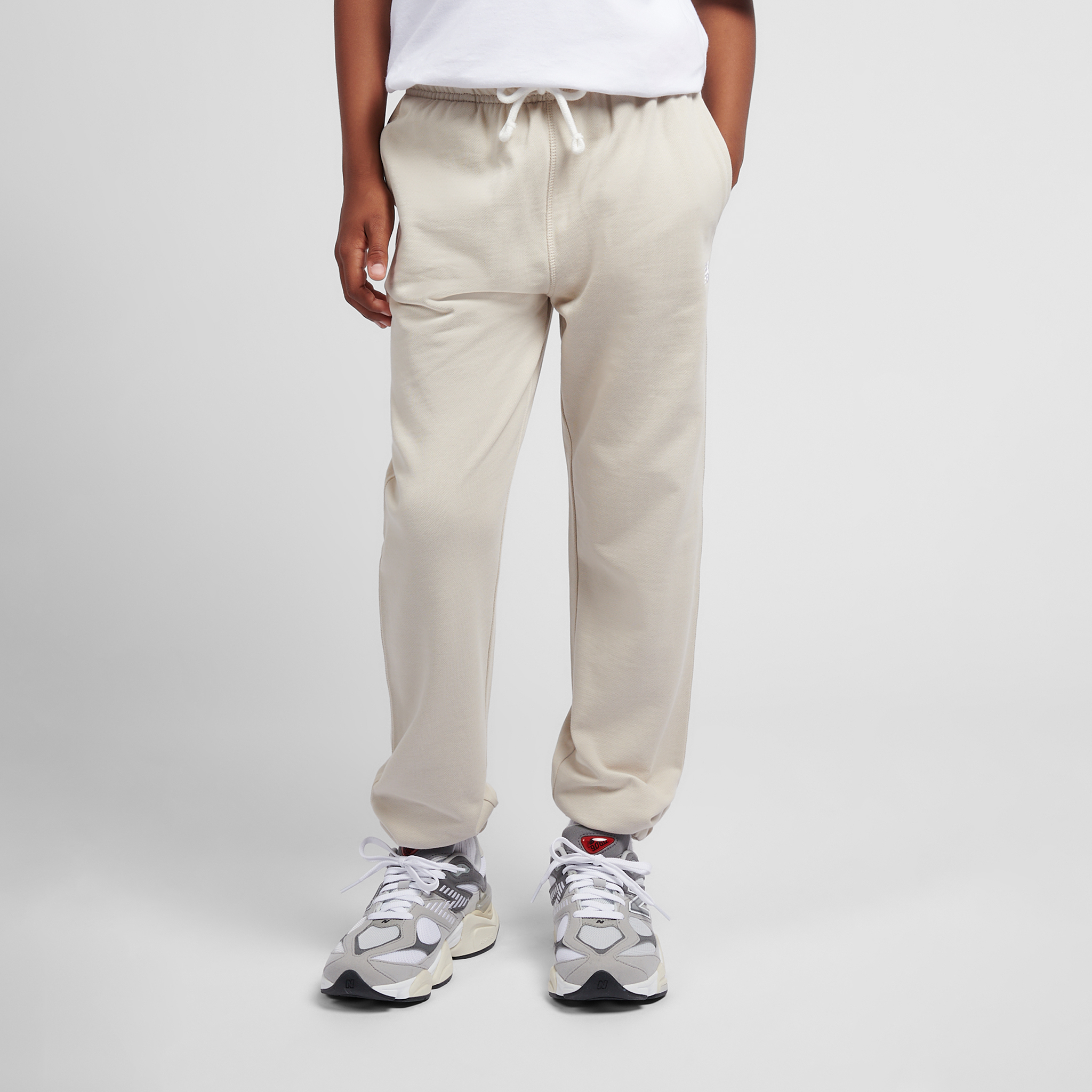 Spodnie dziecięce New Balance LAKB0060TWF – beżowe